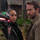 Zoe Saldana holding a gun into the camera.